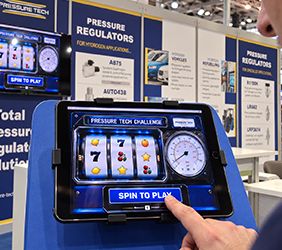Various photos of Pressure Tech's exhibition stand at the Hydrogen Tech World Expo in Hamburg showcasing the new iPad game launched.